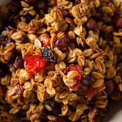 Crunchy honey granola. Dry breakfast cereals with flax seeds, cranberries and nuts. Healthy, vegeterian fiber food. Dieting concept. Close up, top view