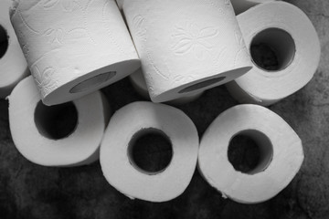 Close up of a lot of toilet paper rolls on a textured background background. Diarrhea, digestive problems concept