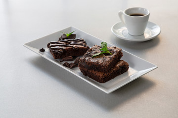 Coffee with chocolate cake with mint leaves