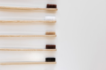 Group of eco bamboo toothbrushes, on white background. Different color. Top view, copy space. Natural organic product for oral hygiene. Dental zero waste and no plastic concept. Safe for the earth.