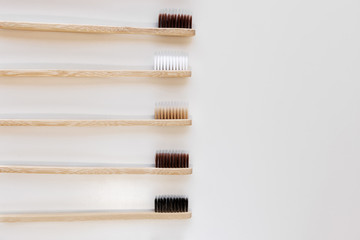 Group of eco bamboo toothbrushes, on white background. Different color. Top view, copy space....