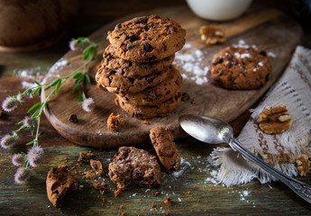 Freshly made chocolate chip cookies on wooden table
