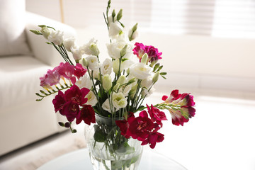 Beautiful bouquet with spring freesia flowers in light room, closeup