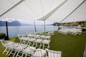 Outdoor preparation for event, white chairs on yard