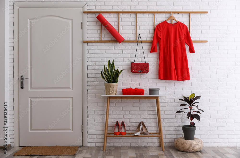 Poster Hallway interior with stylish furniture, shoes and plants