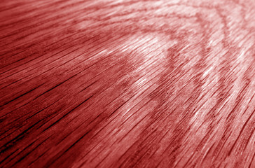 Wooden board texture with blur effect in red tone.