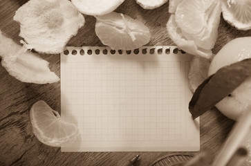 Empty notebook pages and tangerines