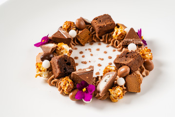 creative dessert with brownie and edible flowers