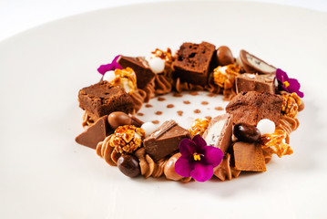 creative dessert with brownie and edible flowers