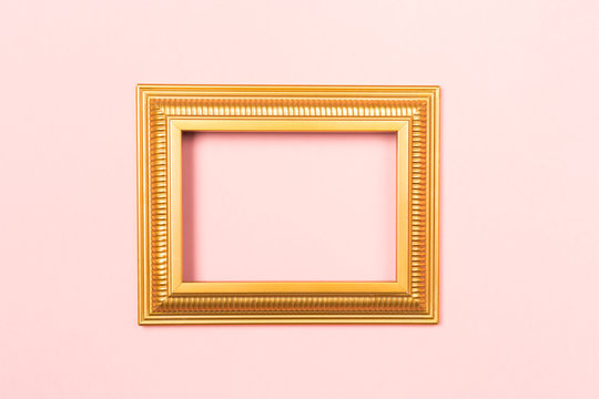 Golden frame empty blank picture on light pink background . Copy space free space for text. Holiday card concept. Mock up. Greeting. Mother's Day. St Valentine's Day. Love .