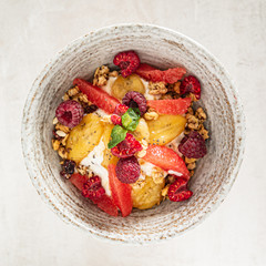 granola with banana and raspberries