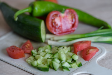 sliced cucumber, tomato, pepper and green onion.