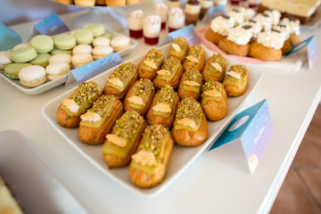 Delicious mini eclairs on candy bar