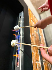 Close-up of marshmallows roasted over a fireplace fire in a house / apartment.