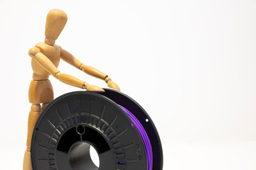 3D printing filament reels with wooden anthropomorphic doll on white background