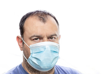 Fototapeta na wymiar Head of the older man with blue surgical protective mask agains pandemic corona covid-19 virus