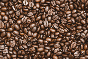 Top view of brown roasted coffee beans, can be use as background, copy space for text.