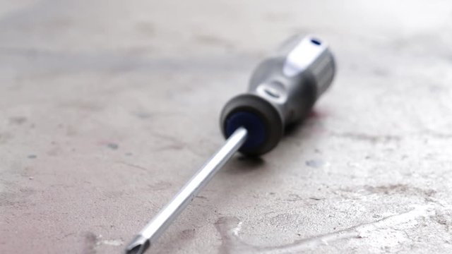 A slider shot of a screwdriver on concrete shot in 59.97 FPS