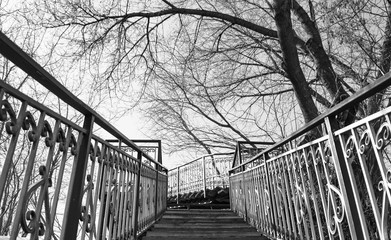 a pedestrian staircase pointing up against the sky where there are no people on the steps