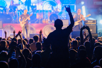 Fans at live rock music concert cheering