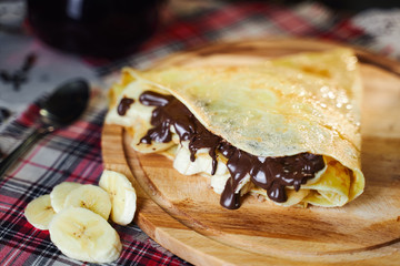 Russian cuisine. Pancakes with banana and chocolate