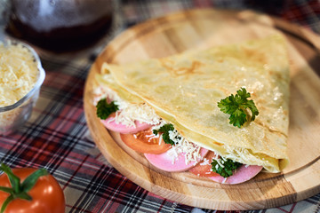 Russian cuisine. Pancakes with cheese and ham