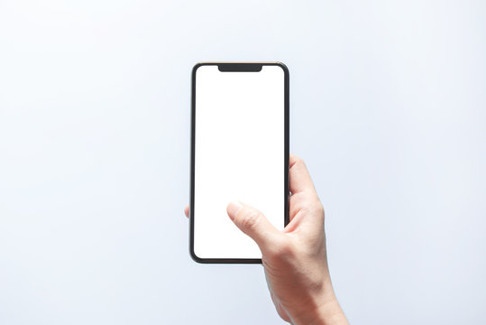 Smartphone mockup. Close up hand holding black phone white screen. Isolated on white background. Mobile phone frameless design concept.