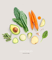 Creative layout made of avocado, carrot, kale, potato, cucumber, garlic and green beans. Flat lay....