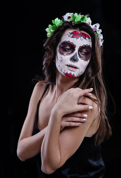 Portrait of a girl with sugar skull makeup over black background. Calavera Catrina. Dia de los muertos. Day of The Dead. Halloween.