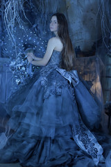 Fototapeta na wymiar Beautiful long haired brunette in gorgeous blue dress