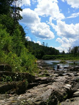 Men Fishing On Rocky Riverbank