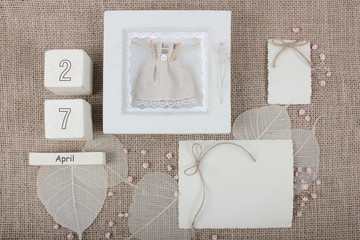 Calendar. April 27th. Wood cube calendar with date of month and day. Newborn postcard concept for girls with copy space. Birthday concept. Greeting or invitation card.