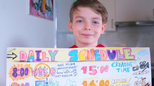 Home education COVID 19. Schoolboy drew daily schedule. Educate children strategies time management from an early age. Turn your child's routine into a checklist. Kids internalize them.