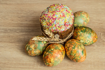 traditional easter cake and easter eggs on wooden background, view from above