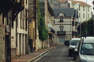 Naklejka premium Typical Normandy architecture and deserted streets with no tourists while citizens stay at home in self isolation. Residential buildings facades, expensive real estate concept, economic crisis
