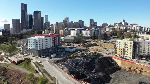 Aerial / drone footage of Yesler Park with new development and construction on hold, empty streets in Yesler Terrace and downtown Seattle, Washington during the COVID-19 pandemic