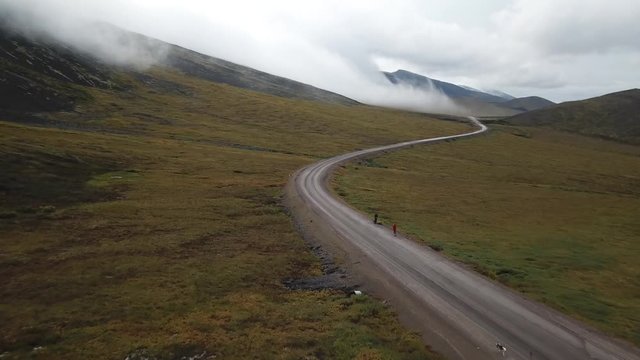 Hitchhikers standing on the side of the mighty Dempster Highway