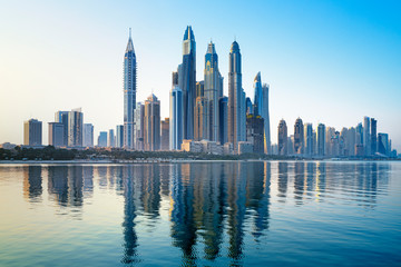 Fototapeta na wymiar Modern and Luxury Dubai Marina with reflection - famous Jumeirah beach at sunrise, United Arab Emirates