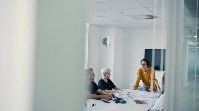 Team of professionals having a meeting in the office conference room. Business team having a brainstorming meeting in the office board room.
