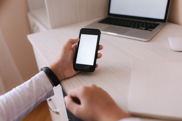 Schoolboy study at desk in his room. Boy use laptop and smartphone to writing in notebook. Books and tablet on the table. Study home during qurantine. Mock up