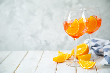 Aperol and ingredients drinks on wood background, copy space