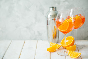 Aperol and ingredients drinks on wood background, copy space