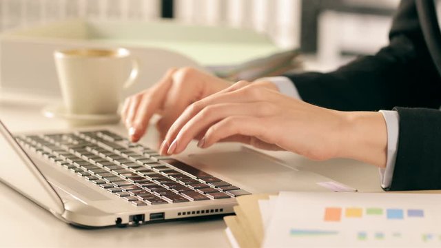 Executive hands typing on laptop at office
