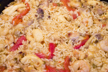 Rice paella cooked with chicken, seafood and vegetables