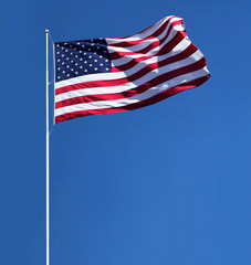 Fototapeta premium American flag on pole isolated on blue sky background including clipping path