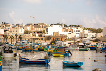 Fototapeta na wymiar Harbour of Marsaxlokk village in Malta with colourful fishing boats