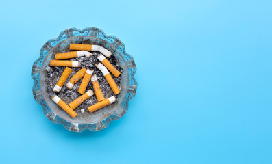 Smoked cigarettes on blue background.