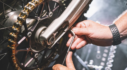 Mechanic working in garage. motorcycle Repair service.