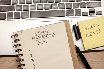 Fotobehang crisis management plan written words in notebook © chechotkin