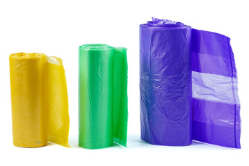 Rolls of yellow, green and purple plastic garbage bags